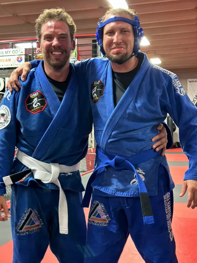 Adult Brazilian Jiu-Jitsu class rolling on the mat at GMA Gallatin